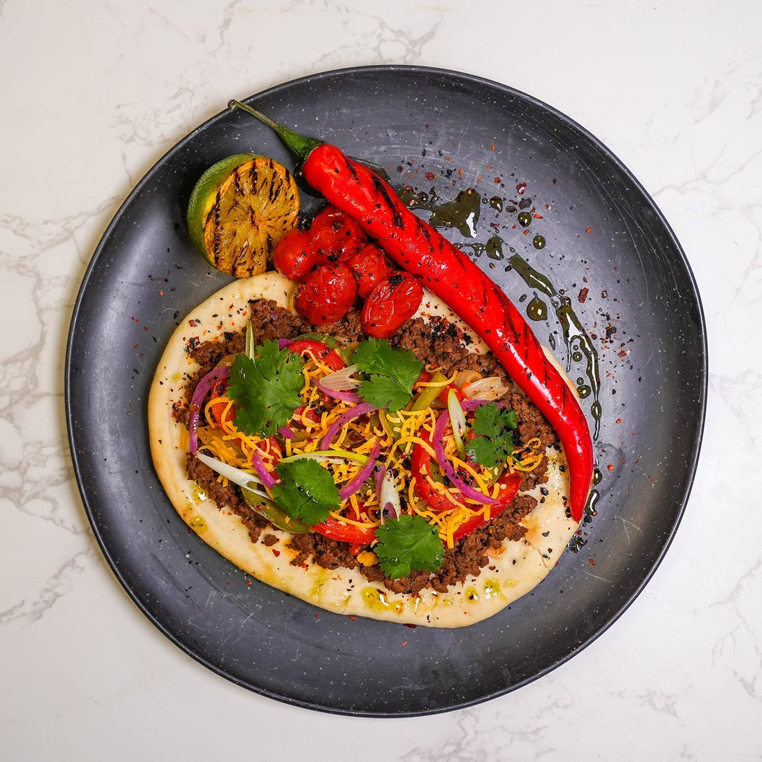 Best meal delivery service meal featuring high protein beef flatbread with grilled vegetables, fresh herbs and balanced nutrition