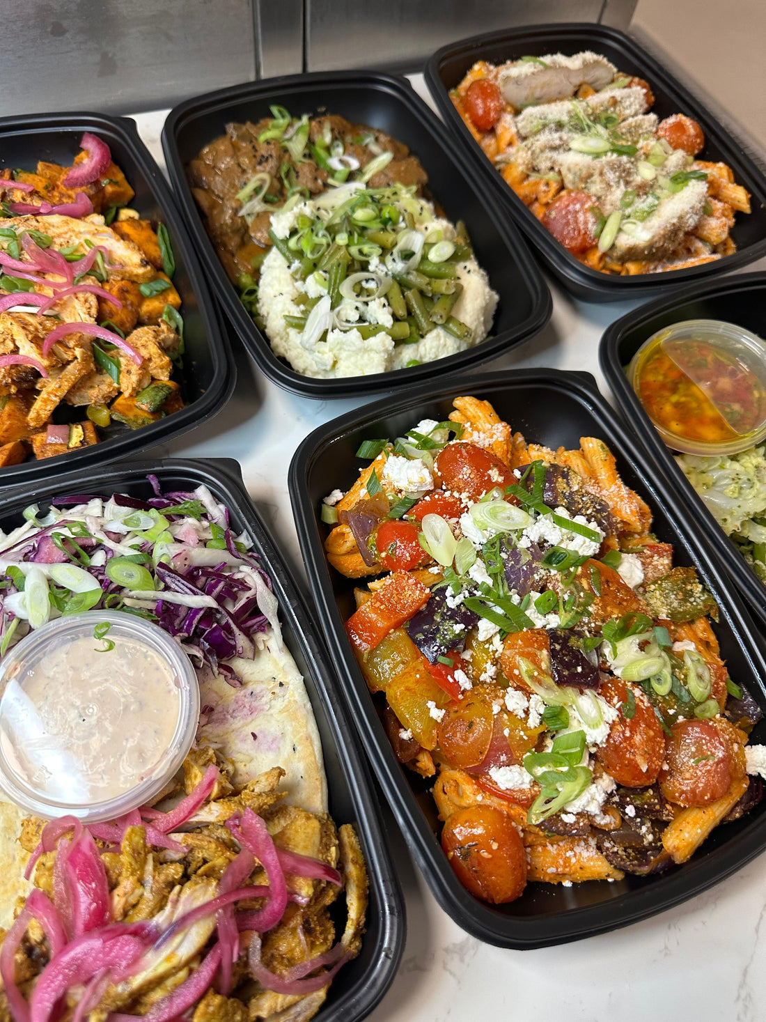 Selection of premium BOZU healthy meal prep meals for families, nutritious high protein meals designed to support convenience, energy and better eating habits.