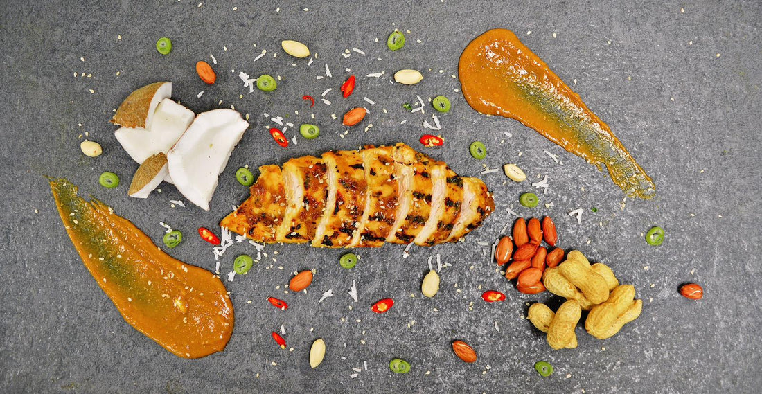 Sliced chicken Meal with fresh garnishes and sauce on a grey slate platter for healthy eating. 