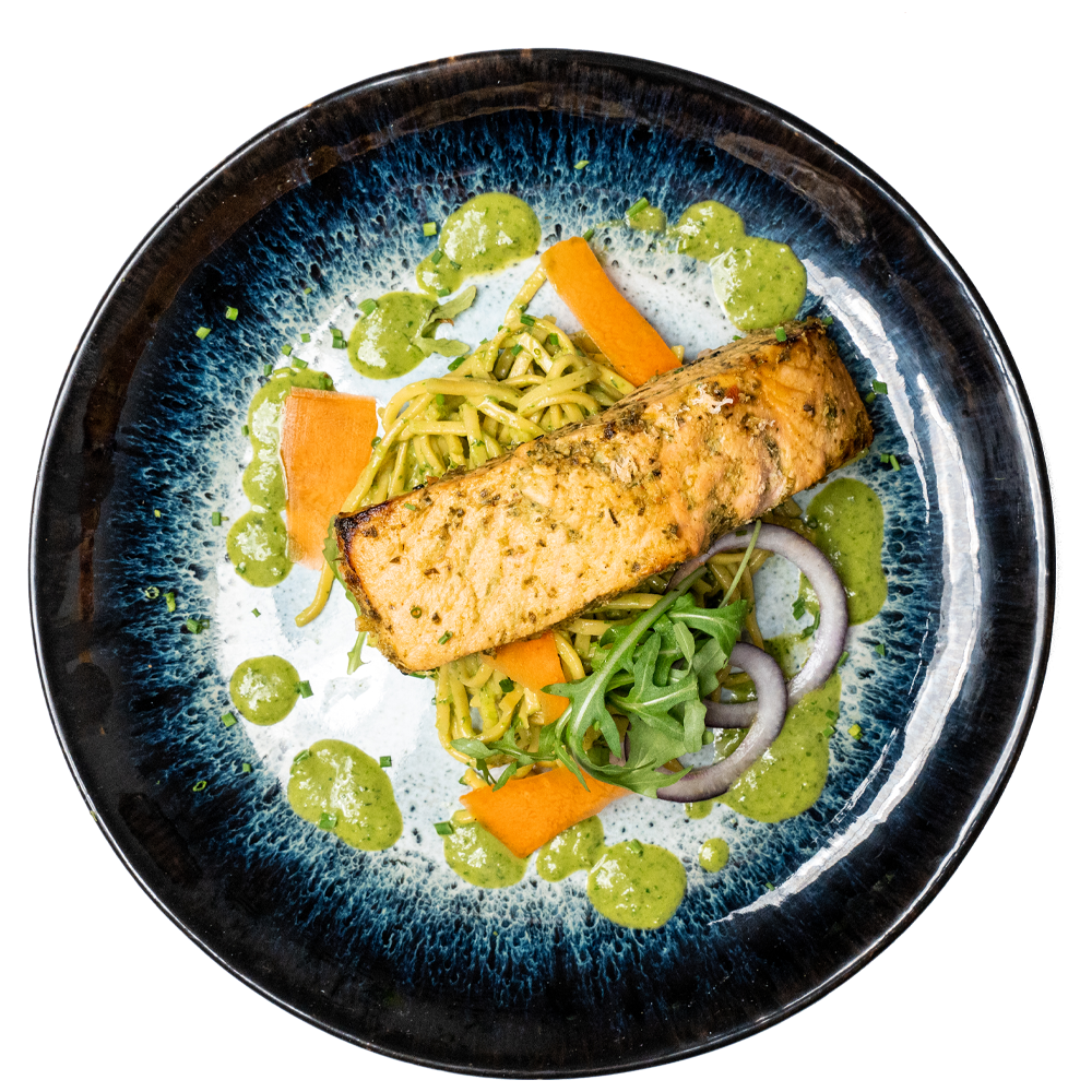 Salmon meal prep with vegetables and green herb sauce, a healthy low-carb meal option at an affordable price.