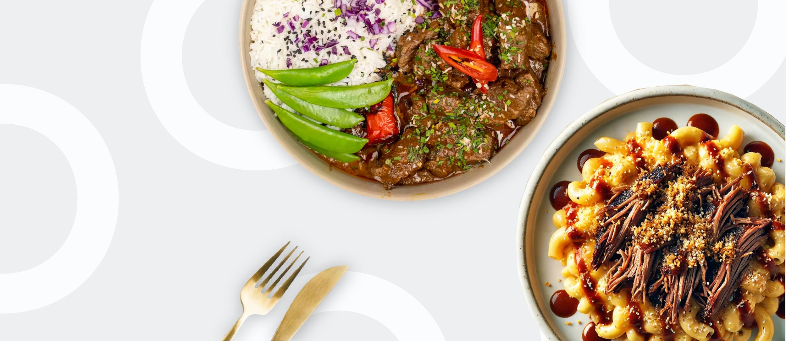 Two BOZU healthy halal meal prep dishes with rice, vegetables and mac and cheese topped with pulled beef alongside gold cutlery.